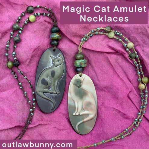 Two magic cat amulet necklaces