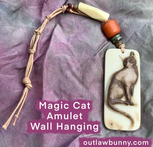 a magic cat amulet wall hanging