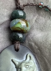 Detail of a magic cat amulet necklace