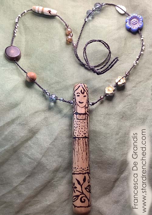 A necklace with a doll as the pendant
